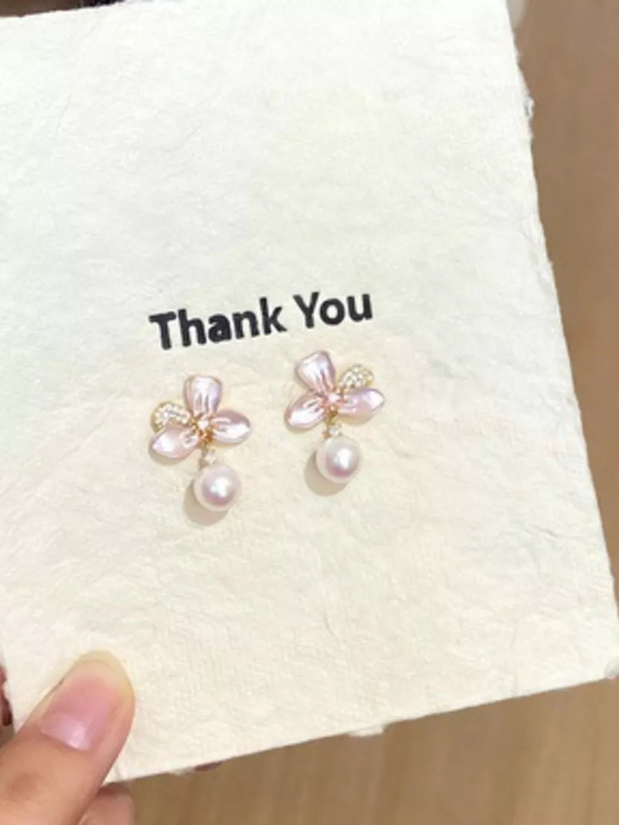Charming pearl blossom drop earrings with delicate pink petals and a single pearl dangle.