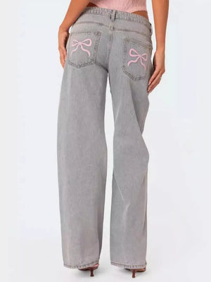 Light grey relaxed fit jeans with pink bow embroidery on back pockets.
