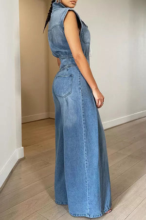 Chic denim jumpsuit with button-front, collared neckline, cinched waist, and wide legs.