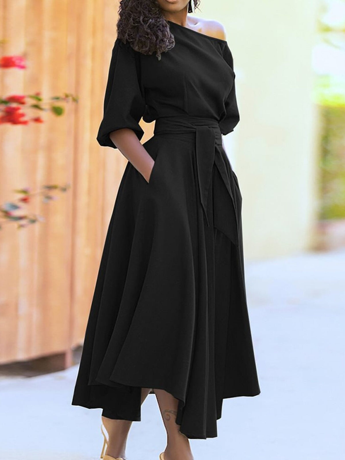 Black belted midi dress with 3/4 sleeves, pockets, and an A-line skirt.