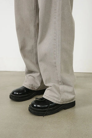 Gray wide-leg denim trousers with seam detail and a relaxed fit.