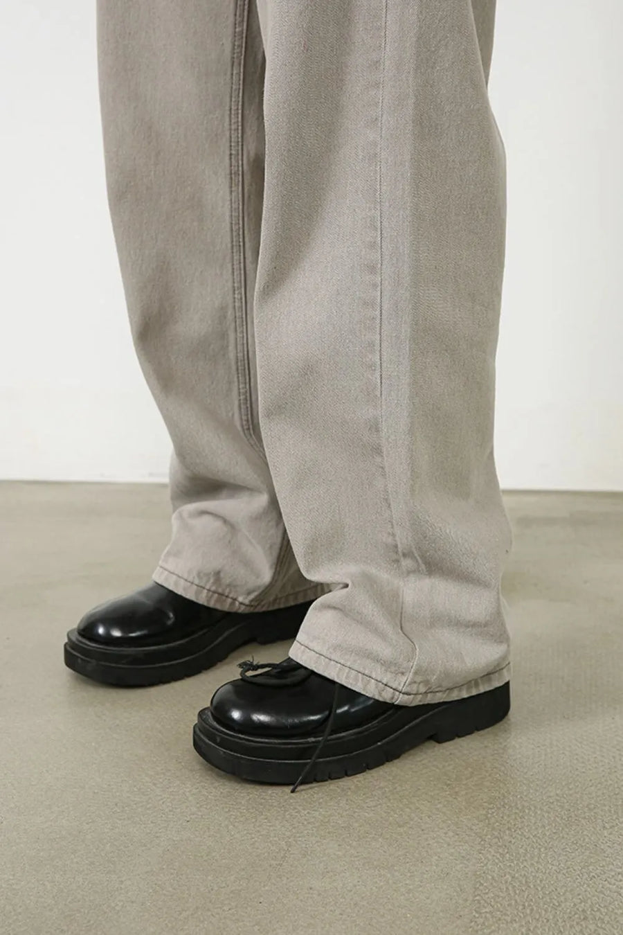 Gray wide-leg denim trousers with seam detail and a relaxed fit.