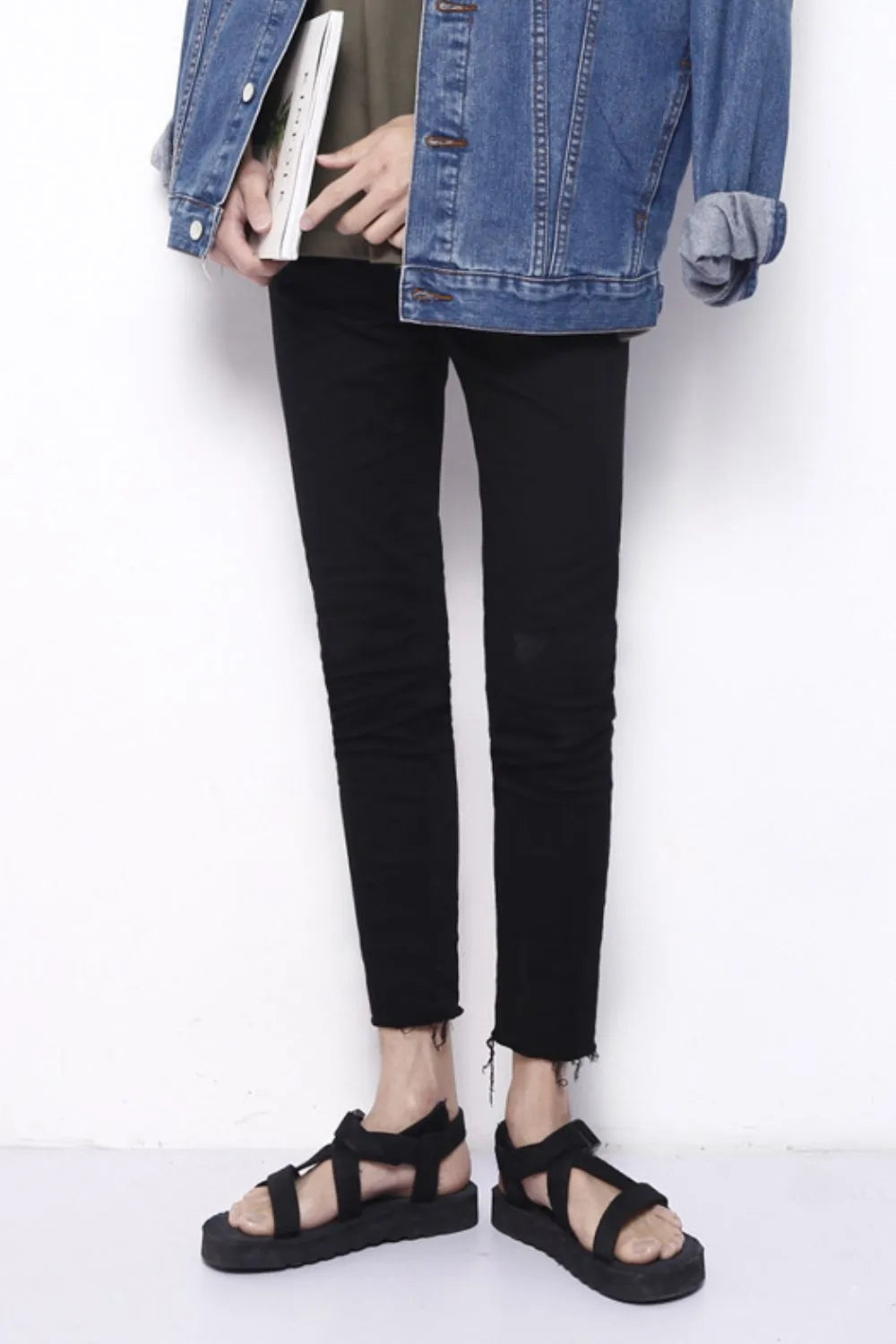 Men's black skinny jeans with raw hem detail