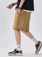 Camel chino shorts with relaxed fit and side pockets, shown on a man.