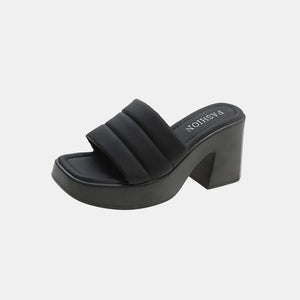 Black padded platform mules with a chunky block heel and square toe.