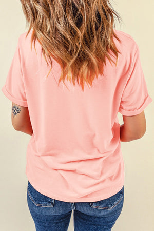 Peach short sleeve t-shirt with rolled cuffs and a patriotic heart graphic on the front.