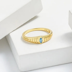 Gold grooved band ring with aquamarine eye detail
