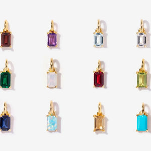 Prism cut gemstone necklace charms in various colors on 18K gold.