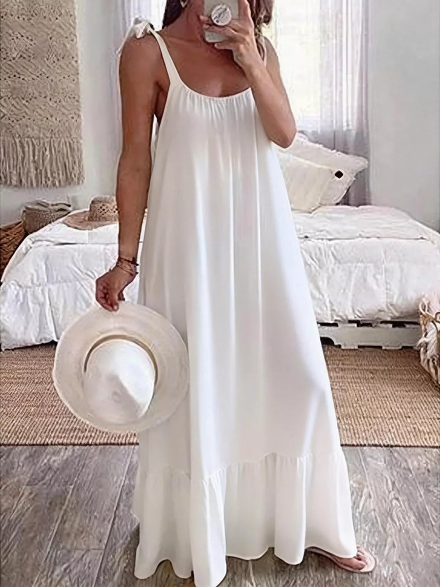 White tie strap maxi dress with ruffled hem, perfect for casual summer wear.