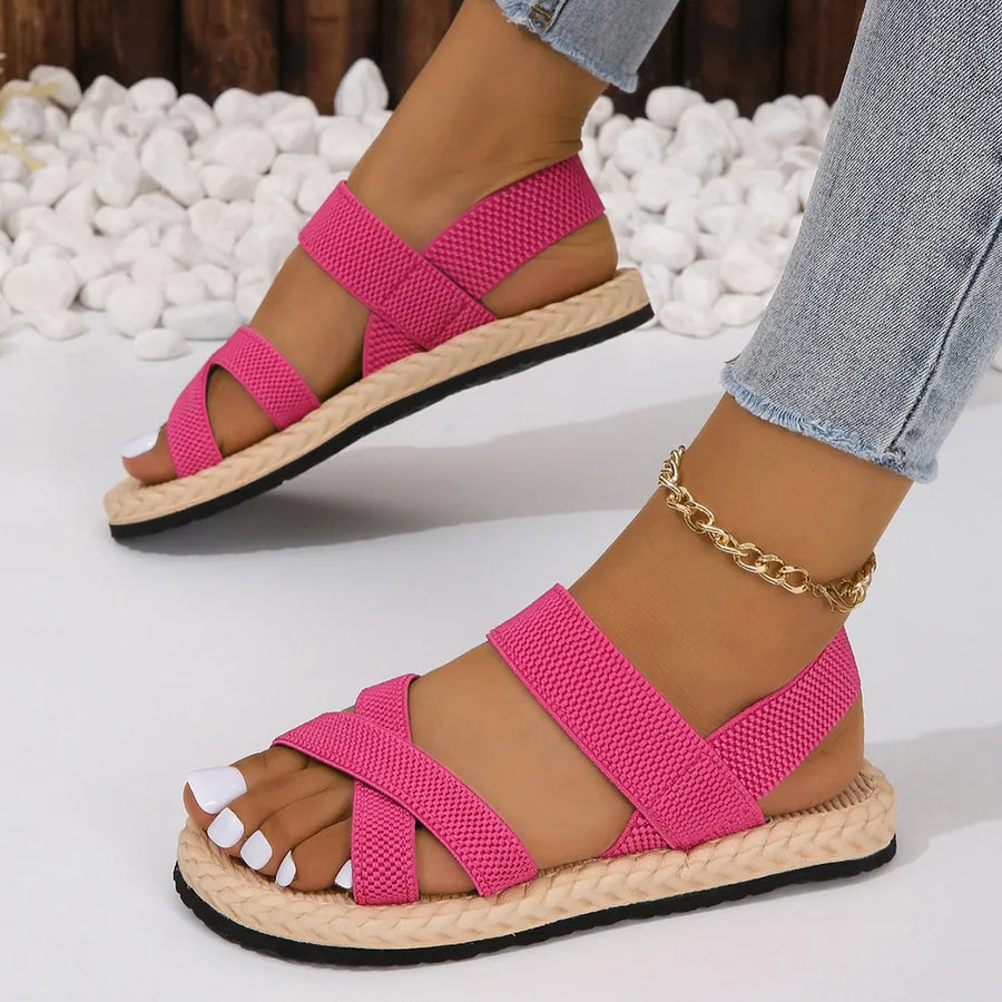 Hot Pink woven sole crossover sandals with elastic straps and espadrille trim.