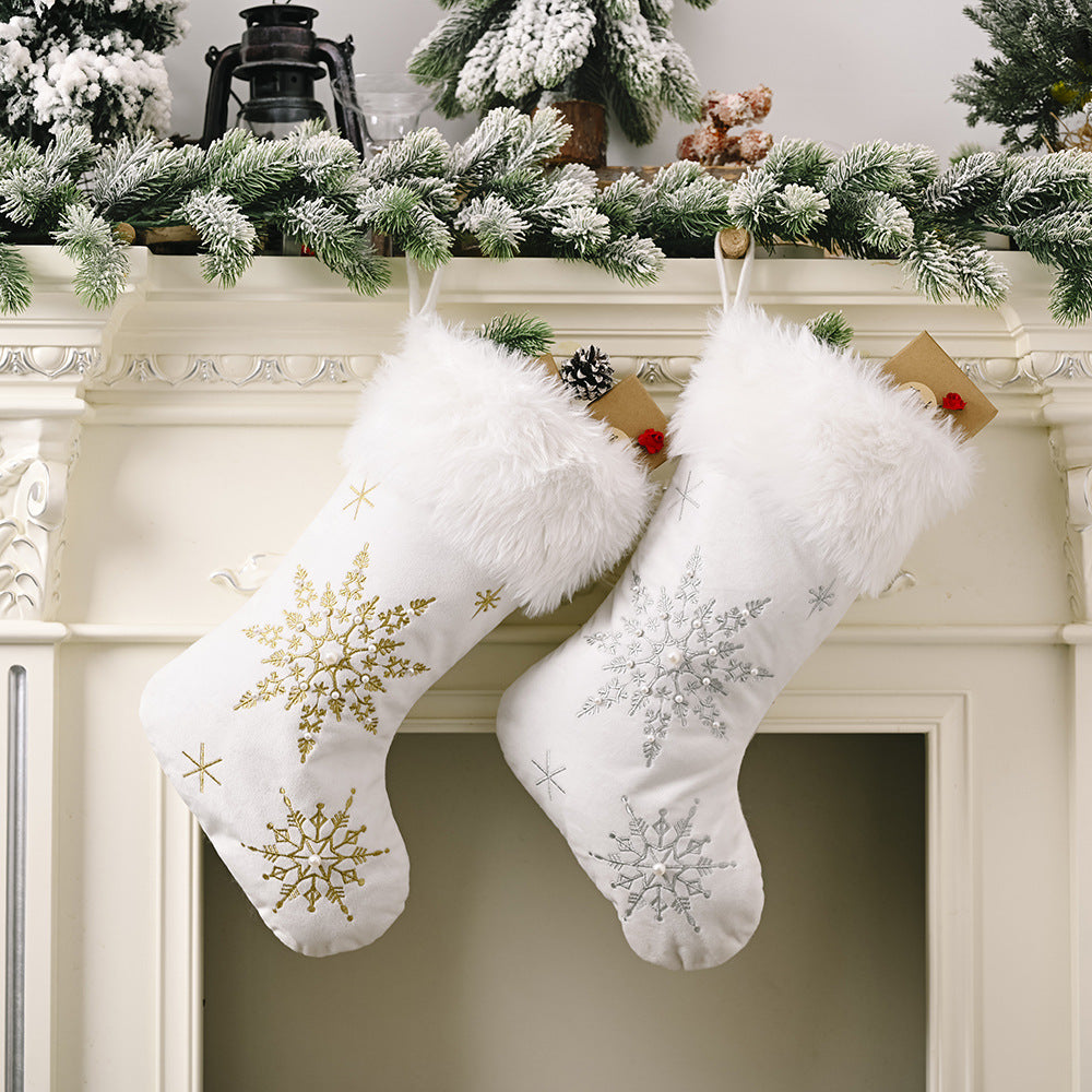 White Christmas stockings with snowflake embroidery in gold and silver, and faux fur trim