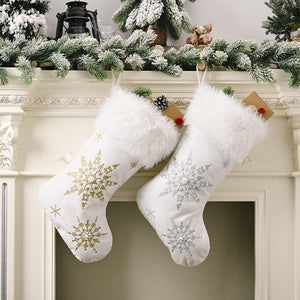 White Christmas stockings with snowflake embroidery in gold and silver, and faux fur trim