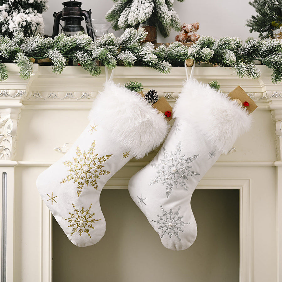 White Christmas stockings with snowflake embroidery in gold and silver, and faux fur trim
