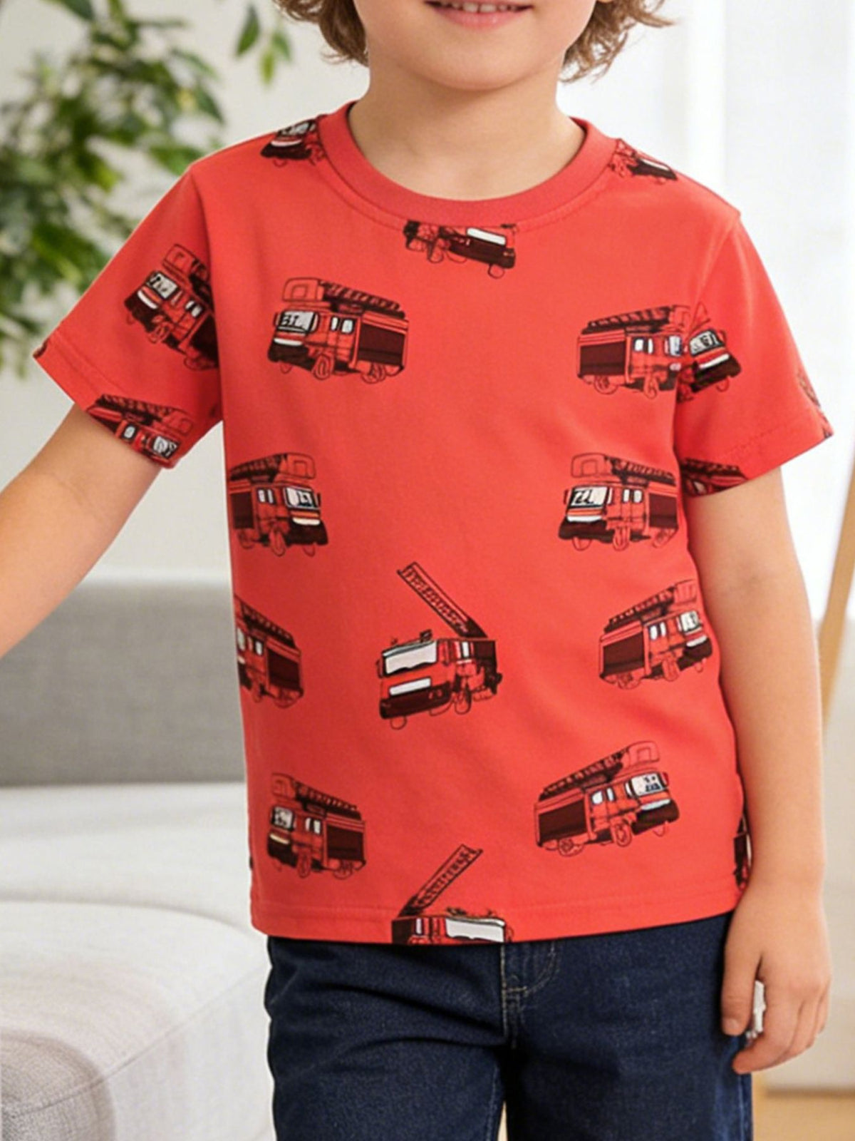 Red cotton toddler t-shirt with all-over fire truck print, crew neck, short sleeves.
