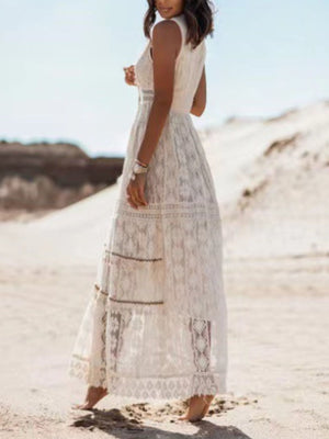 White lace V-neck maxi dress with tiered skirt and intricate patterns.