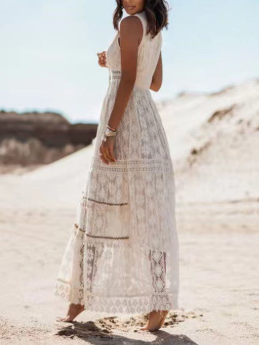 White lace V-neck maxi dress with tiered skirt and intricate patterns.