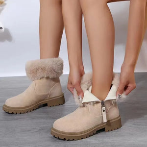 Beige suede shearling trim ankle boots with side zipper and lug sole.