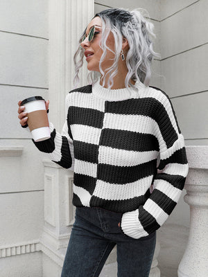 Black and white striped acrylic sweater with a crew neck and long sleeves.