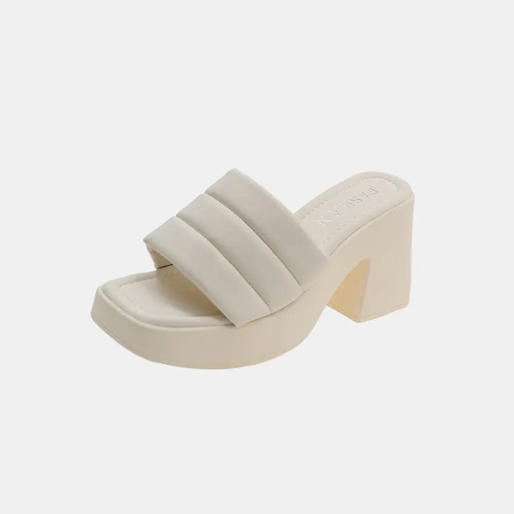 Ivory padded platform mules with a chunky block heel and square toe.