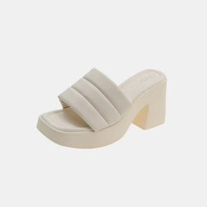 Ivory padded platform mules with a chunky block heel and square toe.