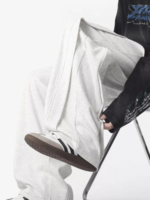 Men's light grey cotton blend drawstring joggers with a loose fit.