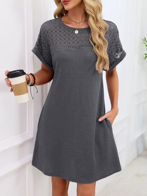 Dark gray t-shirt dress with lace yoke and sleeves, above-knee length, pockets.