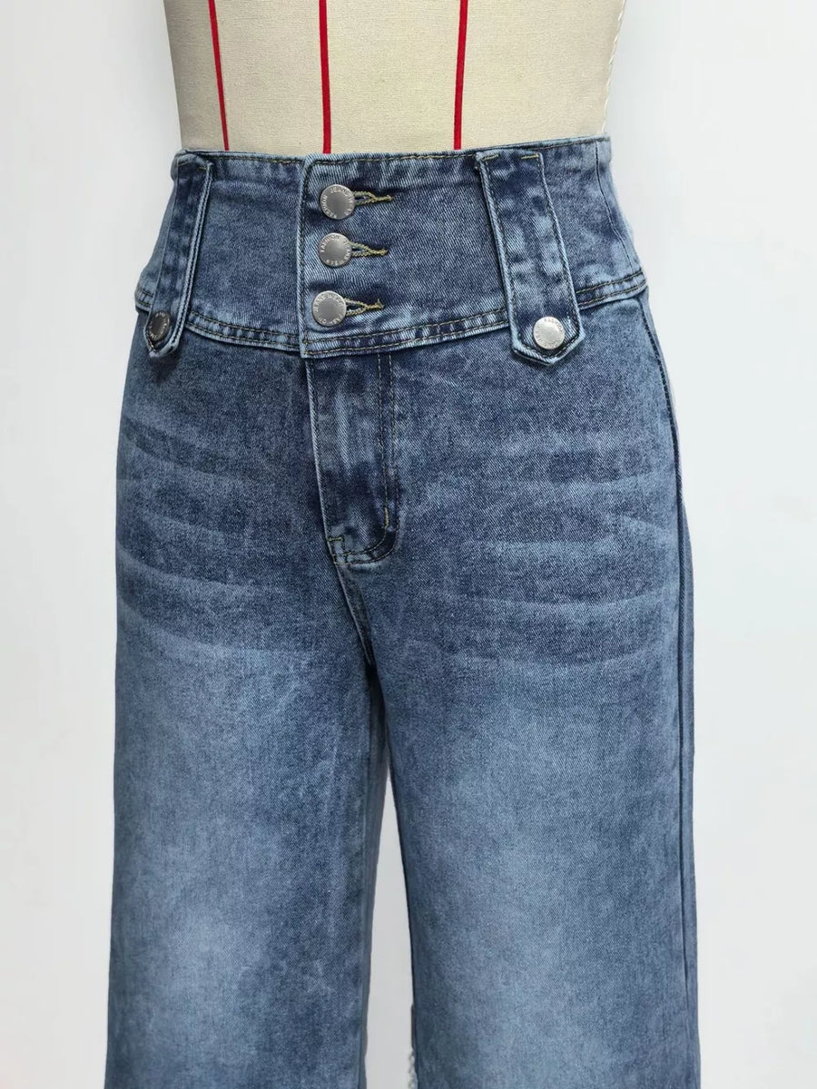 Wide-leg jeans in blue denim with a high waist and three button accents at the fly.