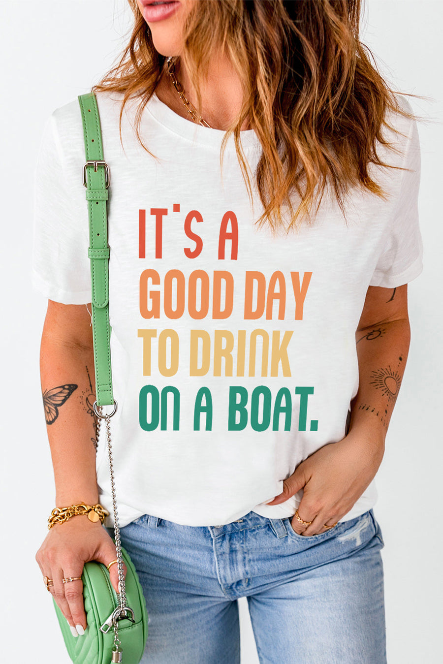 White graphic t-shirt with colorful text reading It's a good day to drink on a boat.