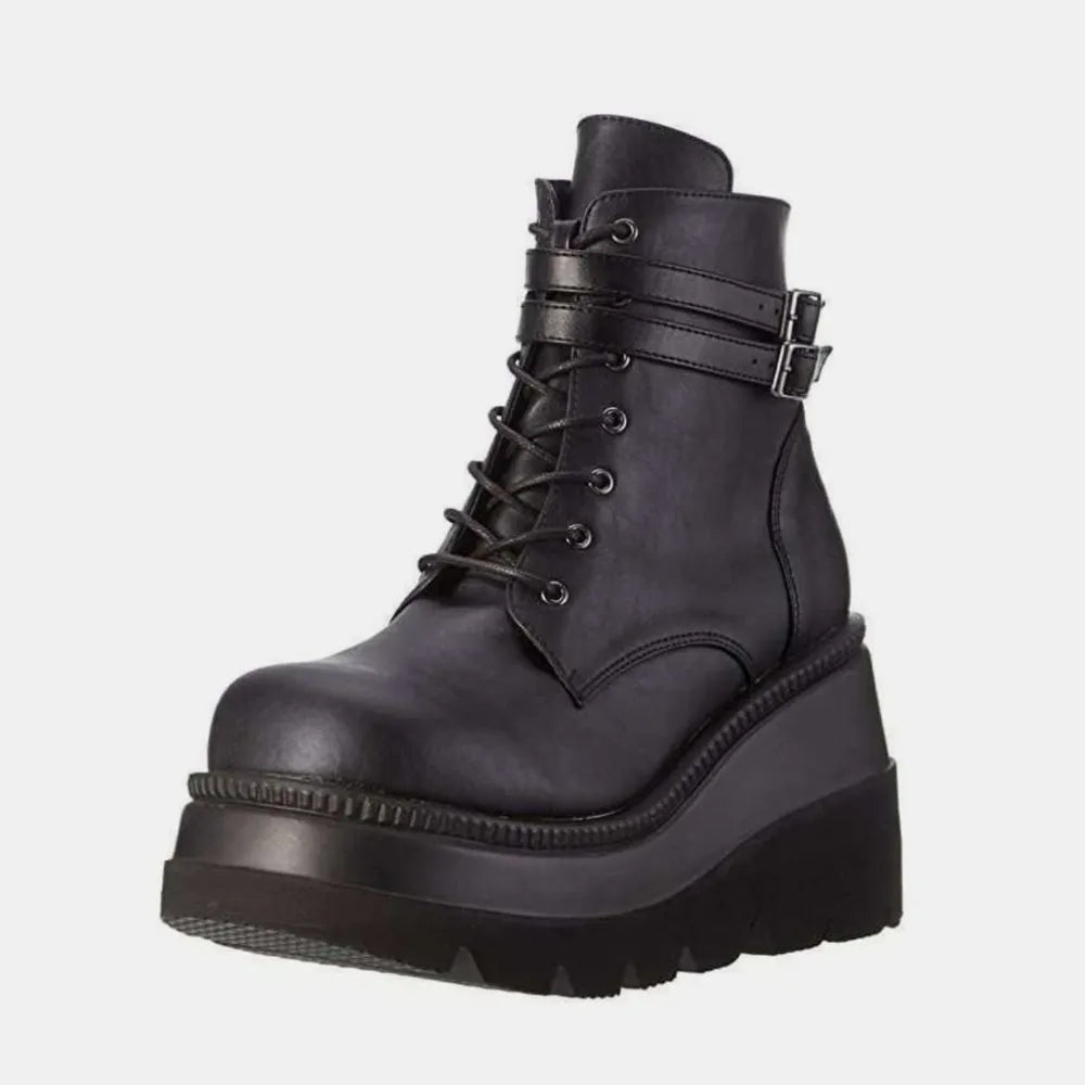 Black platform lace-up booties with double buckle straps and lug sole.