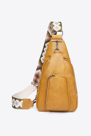 Ochre PU sling bag with a patterned strap and front zip pocket.