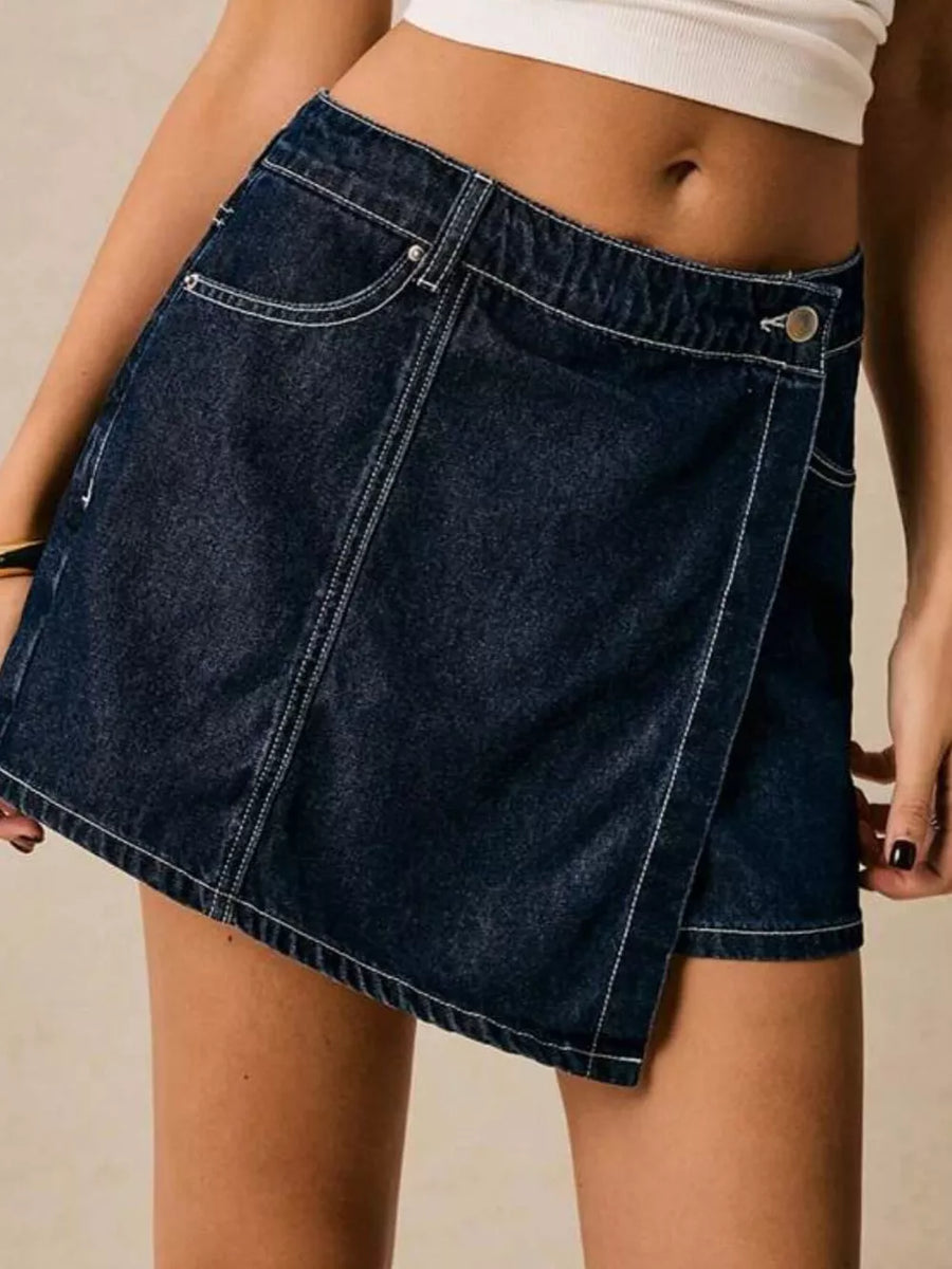 Dark blue denim skort with contrast stitching and a button closure.
