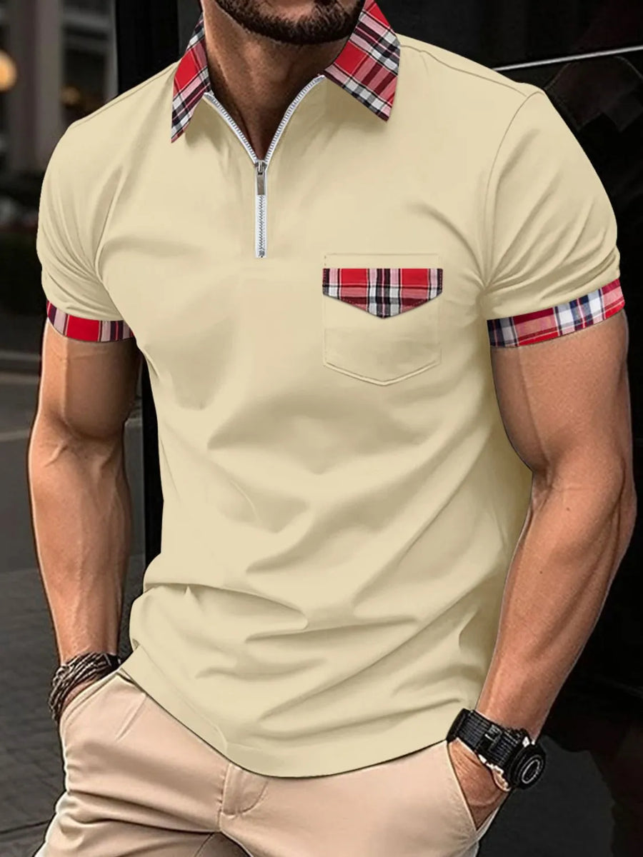 Tan polo shirt with plaid trim on collar, pocket, and sleeves.