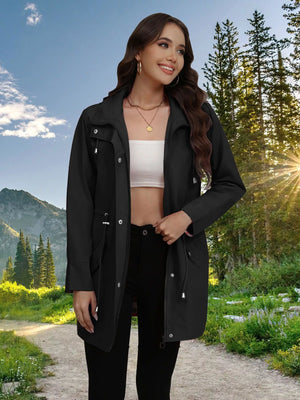 Black drawstring trench coat with snap-down details and a zippered front.
