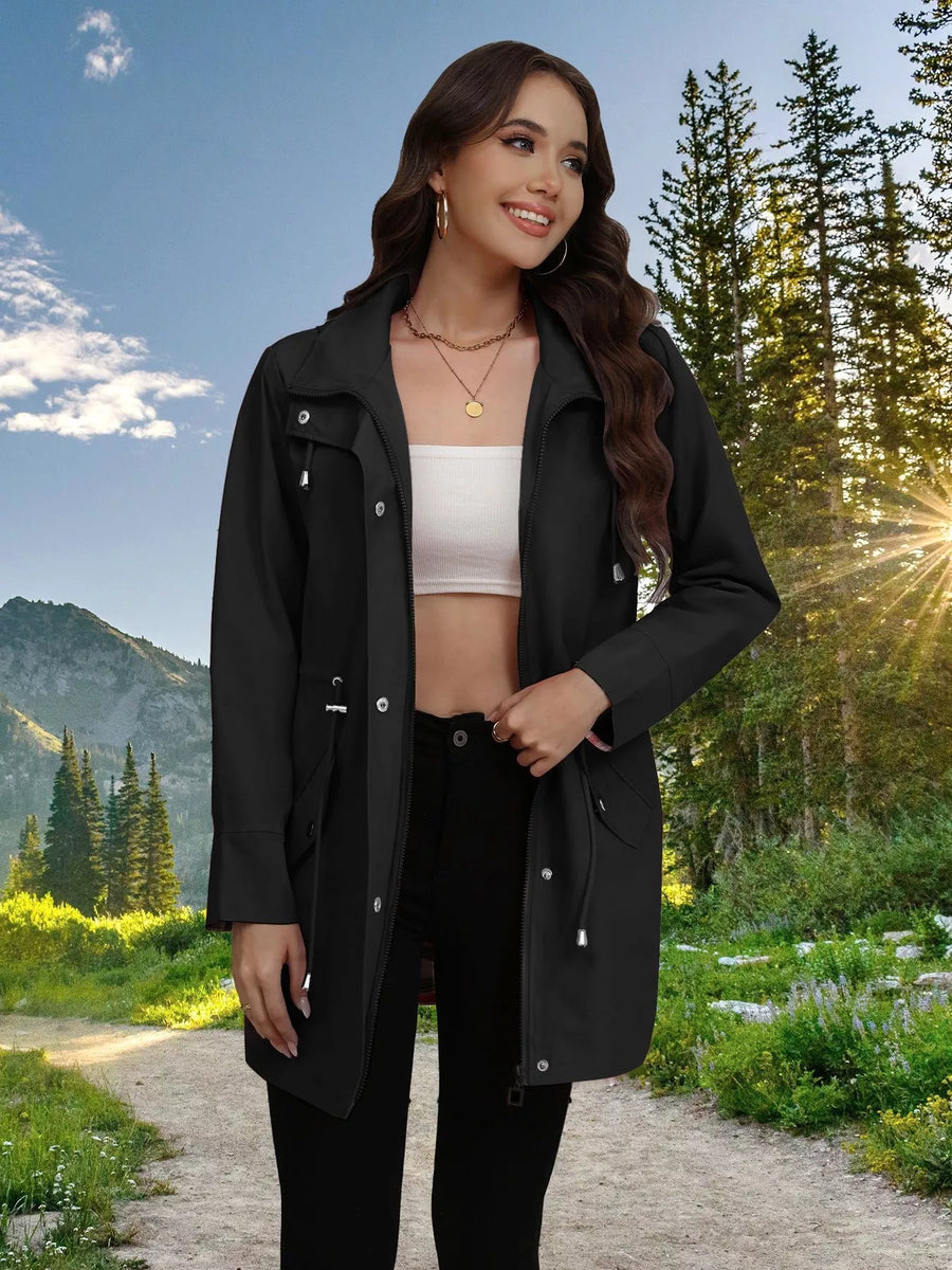 Black drawstring trench coat with snap-down details and a zippered front.