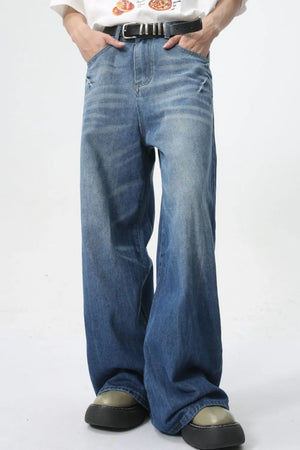 Oversized denim palazzo trousers in medium wash with a wide leg and washed finish.