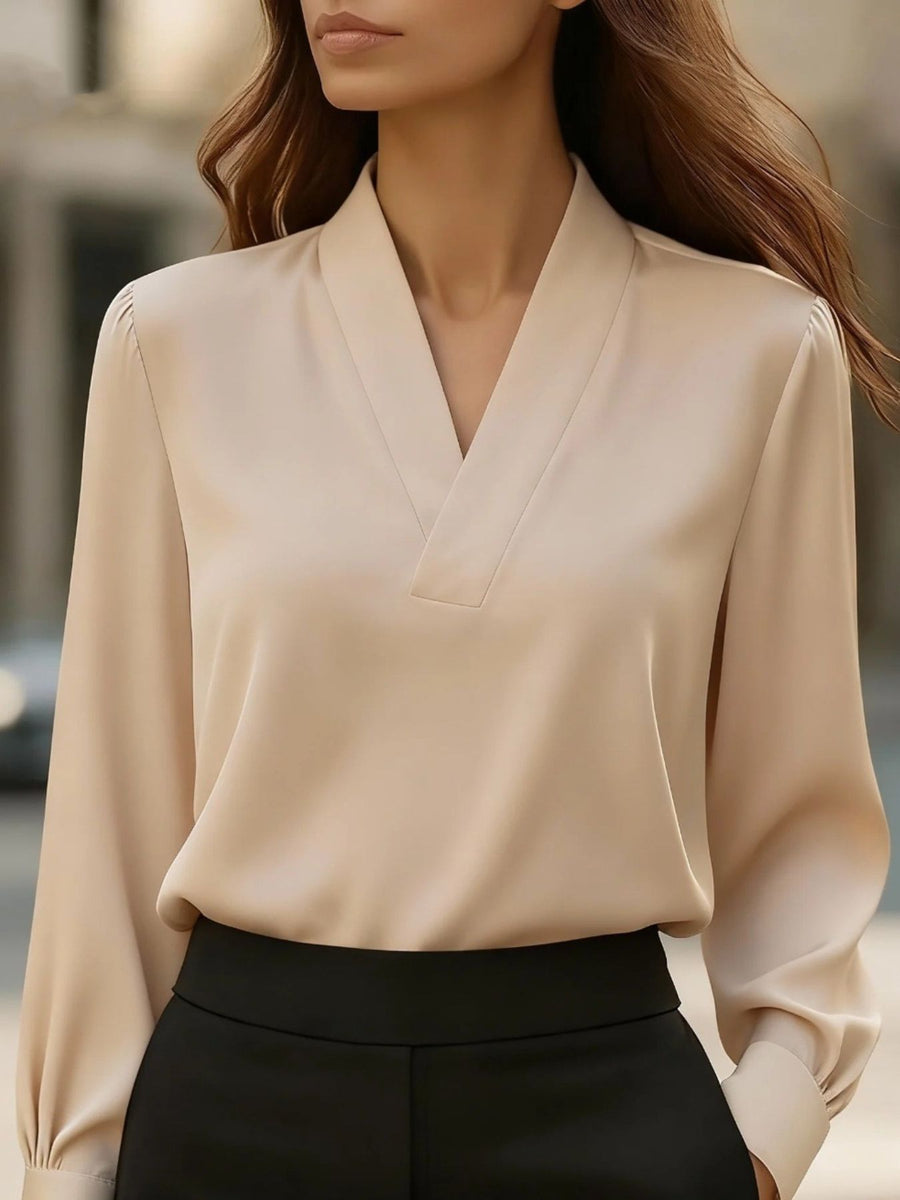 Beige satin V-neck blouse with long sleeves and a relaxed fit.