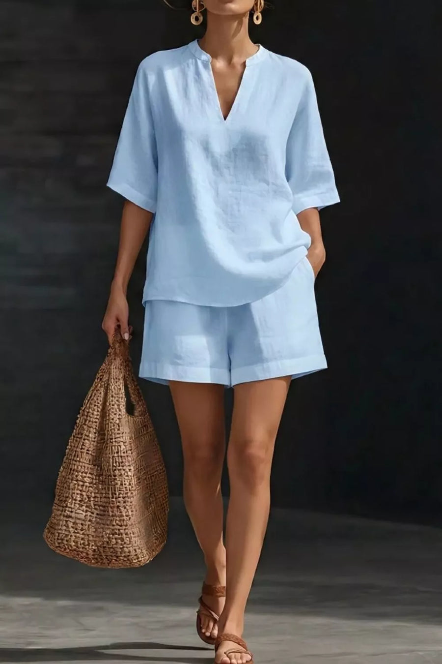 Light blue notched top and pocketed shorts set with V-neck and short sleeves.