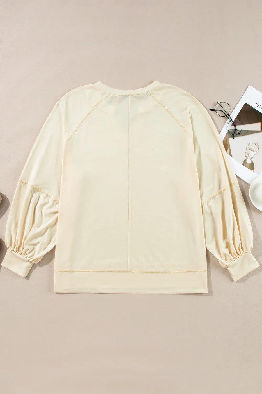 Gathered sleeve pastel yellow blouse with a V-neck and relaxed fit.