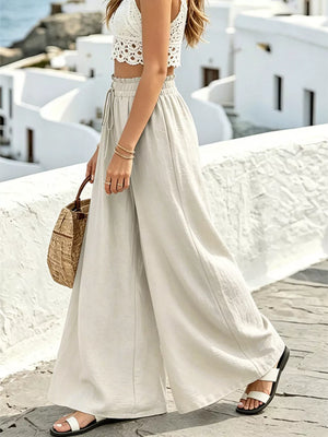Wide leg linen pants in light beige with drawstring waist and white lace crop top