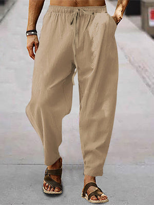 Men's khaki drawstring wide leg sweatpants with pockets.