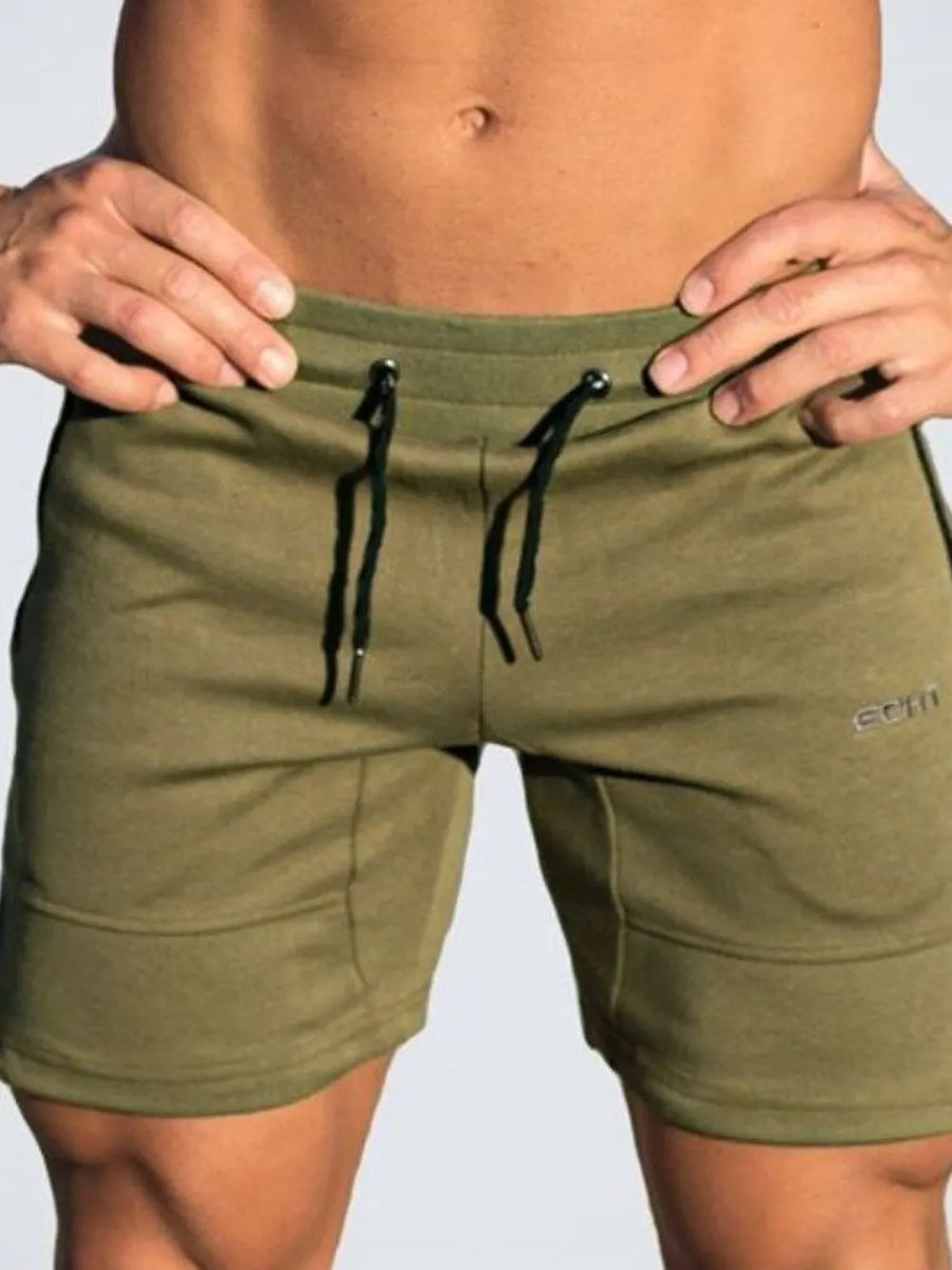 Moss green training shorts with drawstring and subtle logo detail.