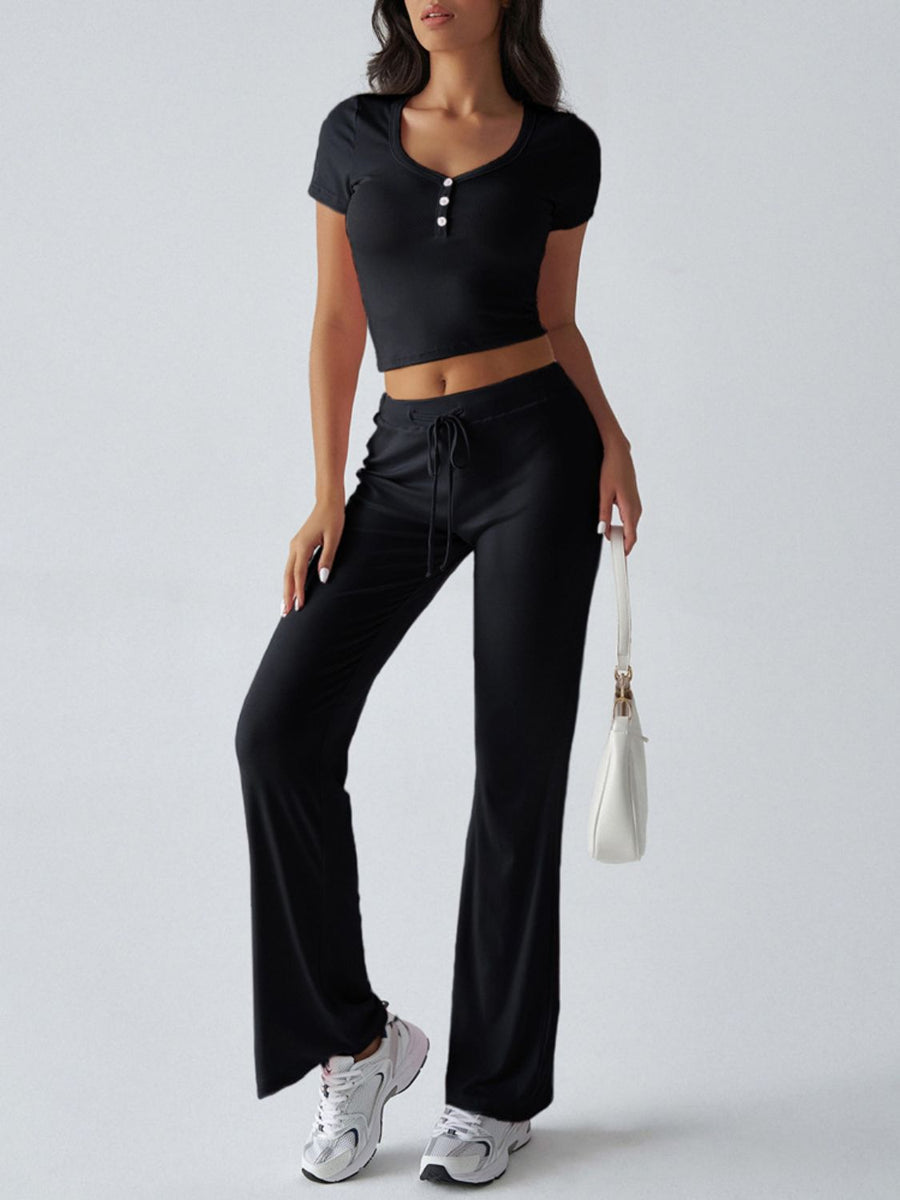 Black button-front crop top and flared lounge pants with drawstring waist.