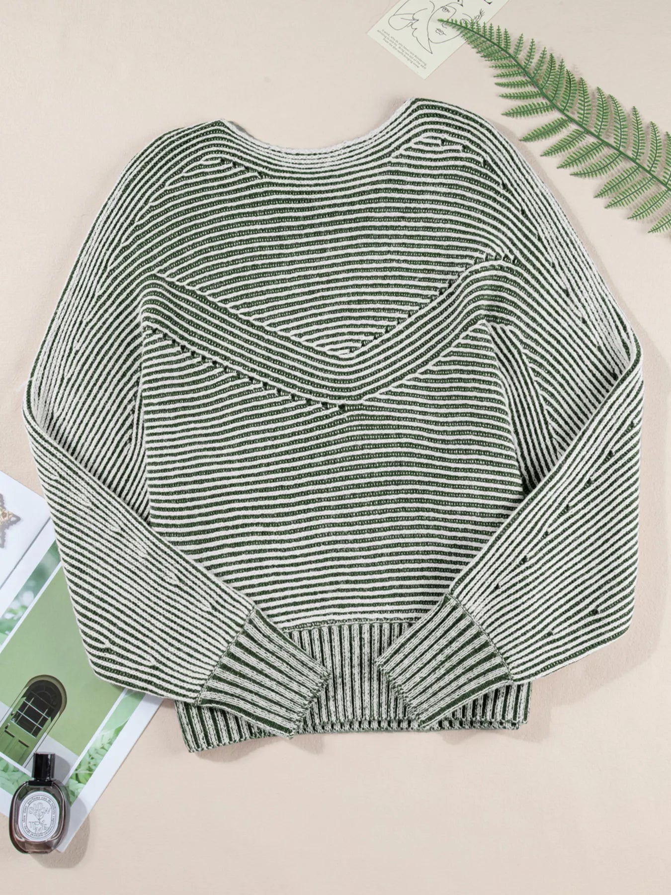 Relaxed ribbed knit boat neck sweater in stripe with a V-shaped yoke detail.