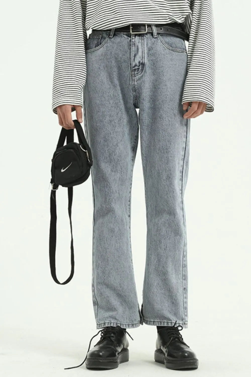 Medium wash acid wash denim jeans with a straight leg cut and split hem detail.