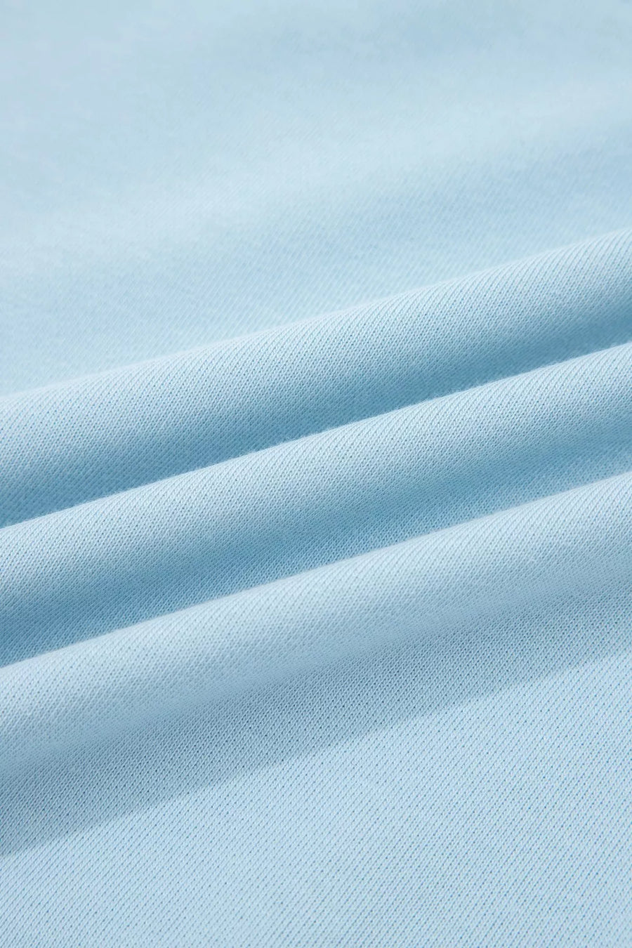 Light blue cotton bikini fabric with textured weave and soft folds.