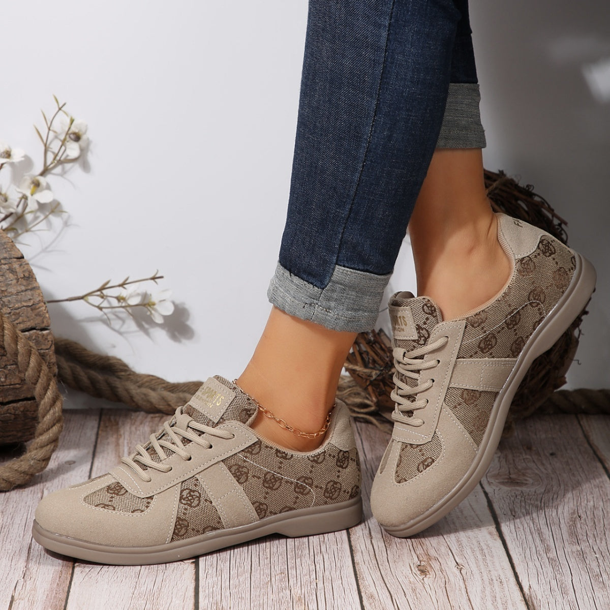 Chic lace-up sneakers with monogram pattern and beige suede accents.