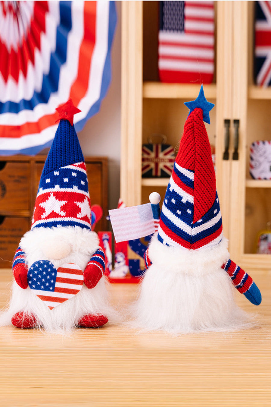 Patriotic knit gnomes in red and blue, one holding a heart, the other a flag.