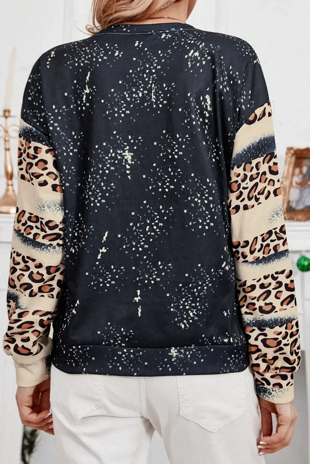 Black sweatshirt with leopard print sleeves and splatter detail