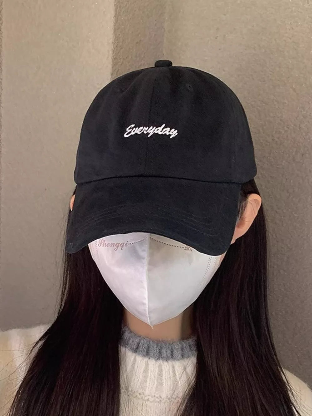 Black cotton baseball cap with white embroidered "Everyday" detail.
