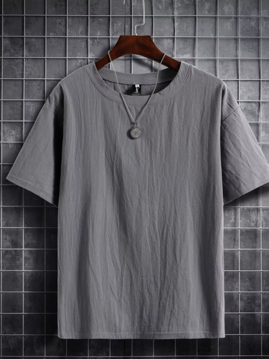 Grey cotton crew neck t-shirt with textured fabric and short sleeves.